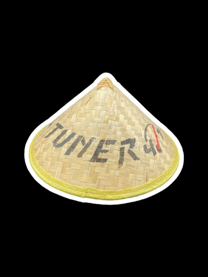 Tan woven conical TUNER4/7 hat with yellow edge trim and dark lettering.
